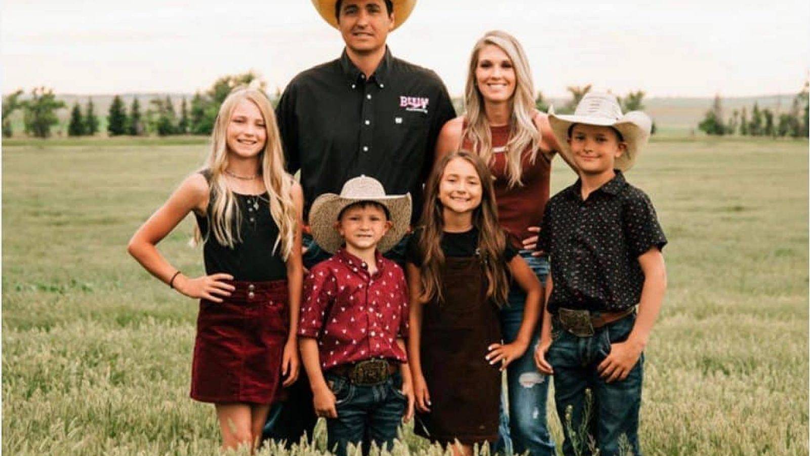 A ranch family standing in a field.
