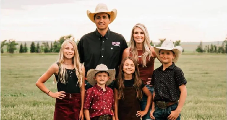 A ranch family standing in a field.