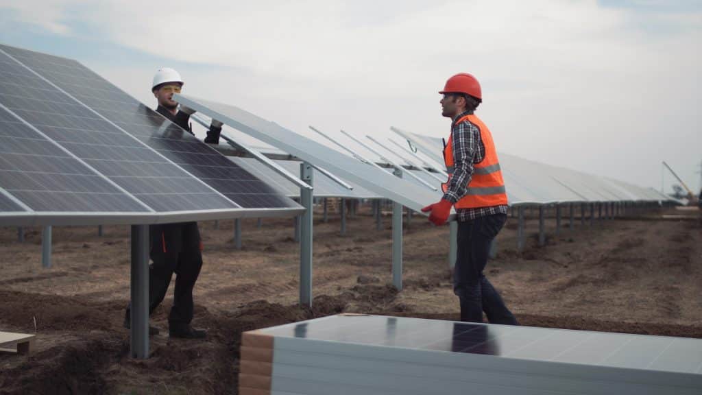 Workers installing solar panels