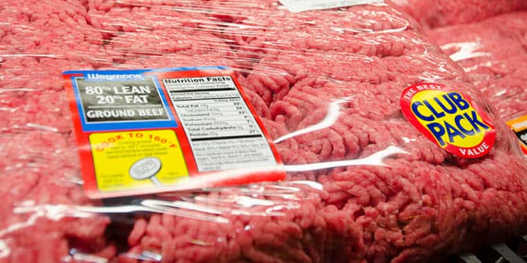 A package of ground hamburger in a grocery store meat case.