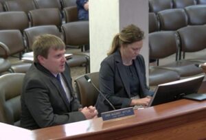 Law enforcement with an attorney at a hearing