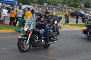 A man and a woman riding a motorcycle