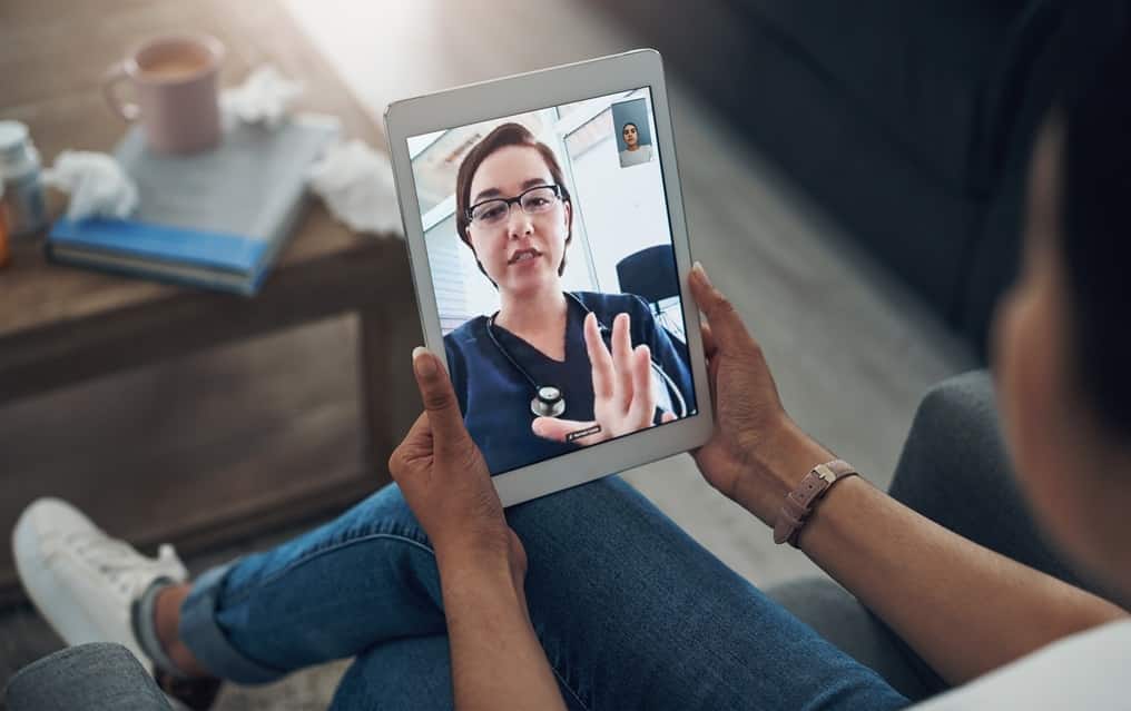 A health care provider takes part in a telehealth appointment.