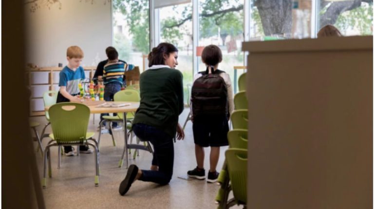 Children and teacher in a classroom.